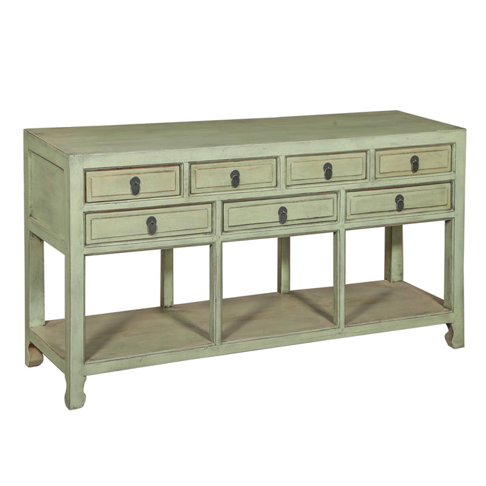 Hand-finished reclaimed solid wood cabinet with seven paneled drawers, antique ring pulls, and open lower shelf in distressed sage green